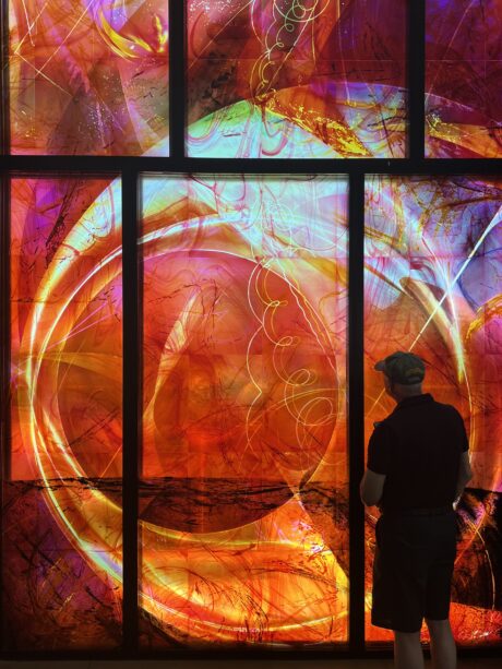 Contemporary stained glass Marian Window close-up with figure silhouetted in radiant color, liturgical glass commission for new church construction