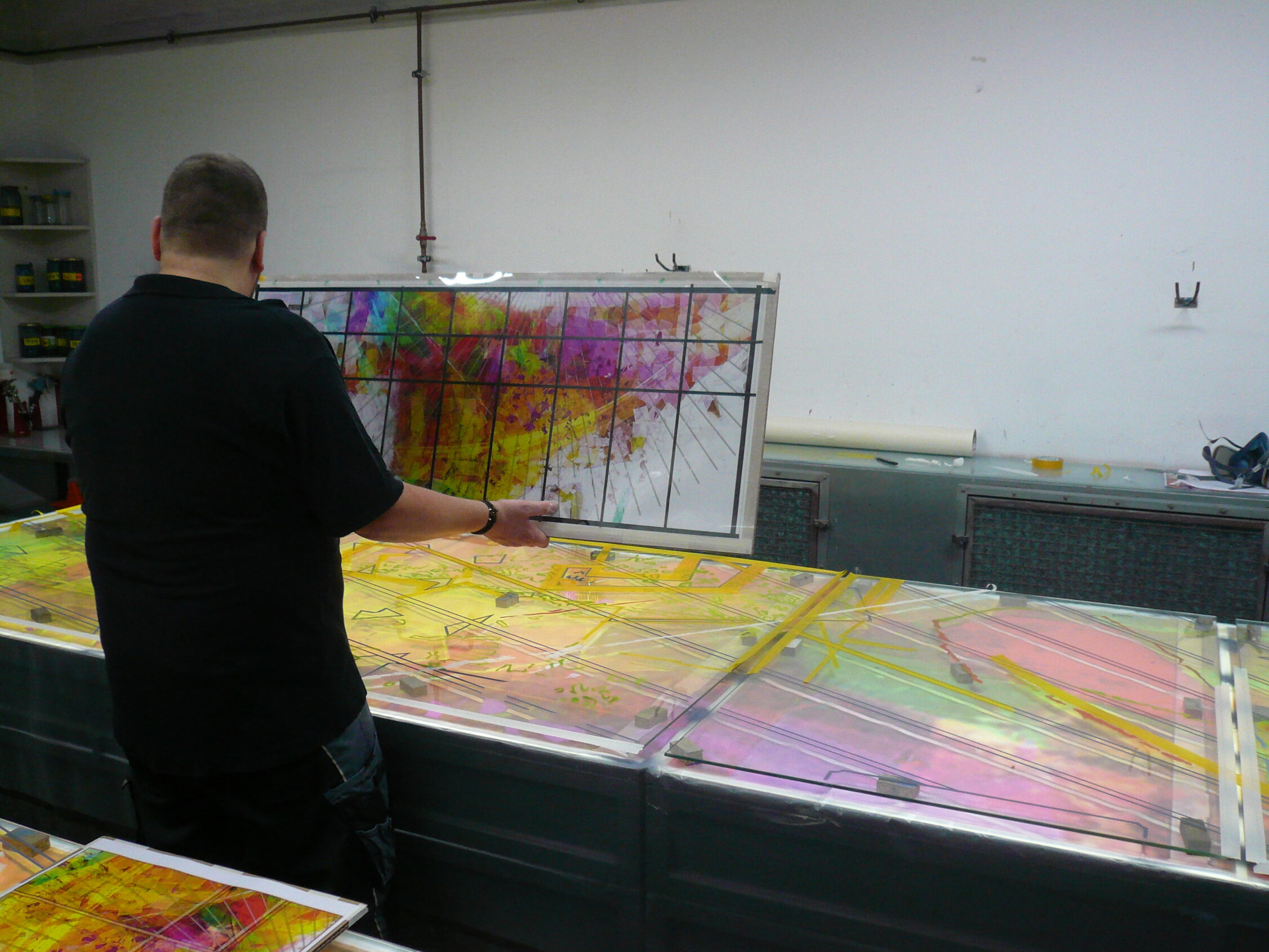 In the airbrush studio, Olaf is planning the next steps in glass painting
