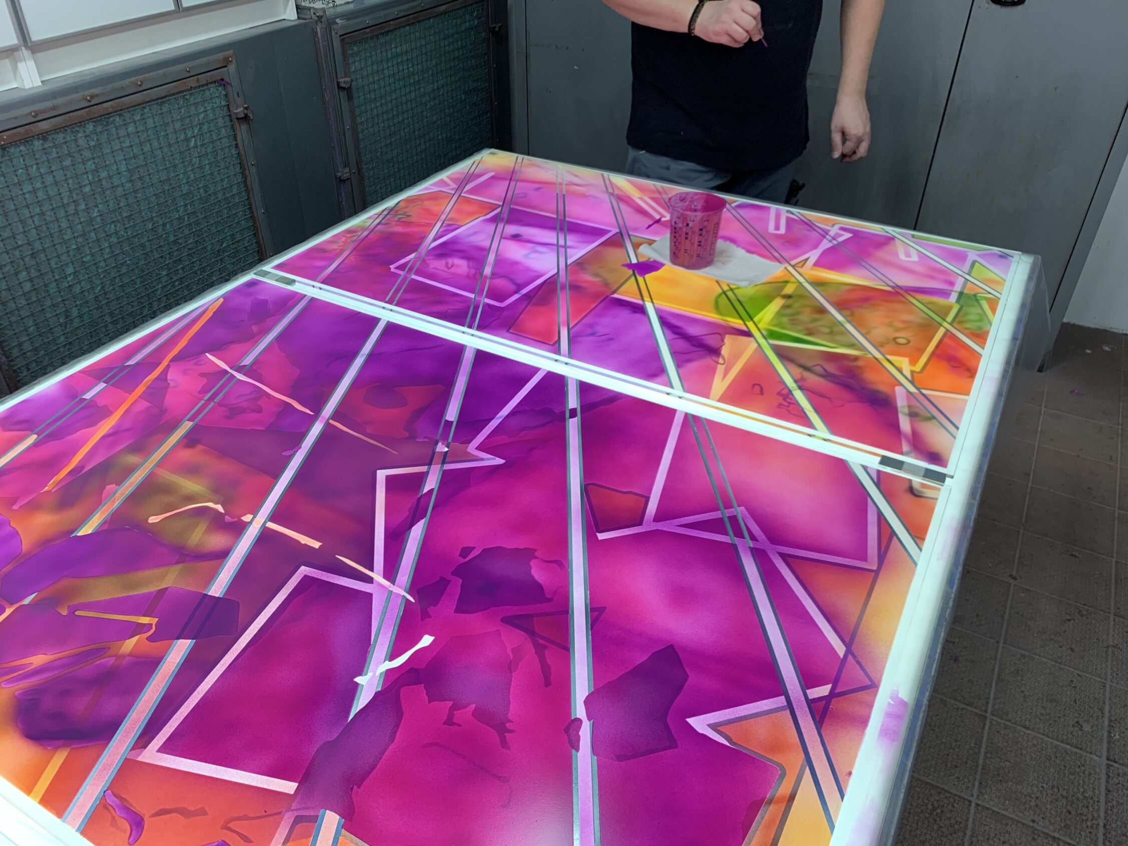 Handpainting in the spay booth at Derix Glasstudios