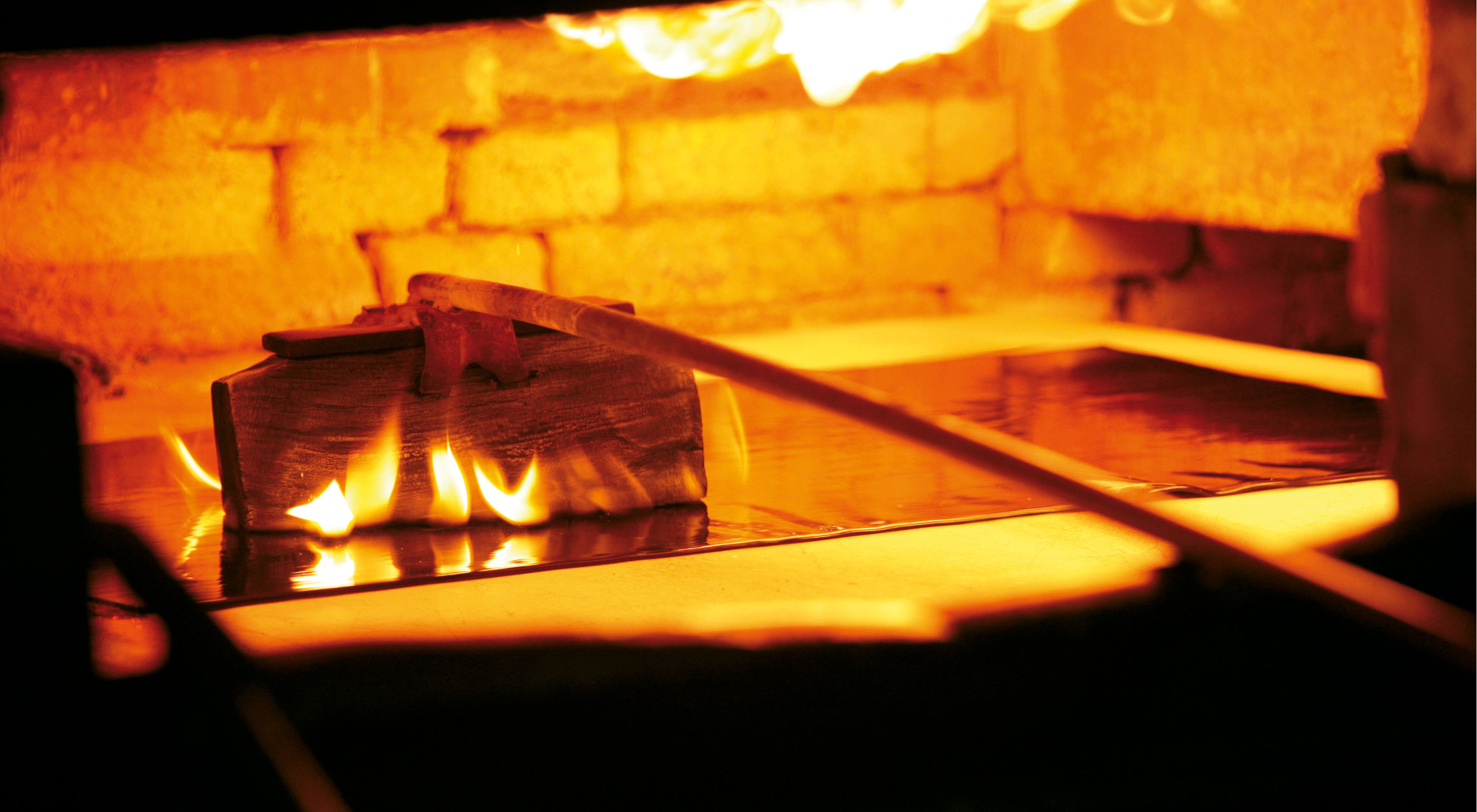 Flattening the glass cylinder into a sheet of glass at Lamberts