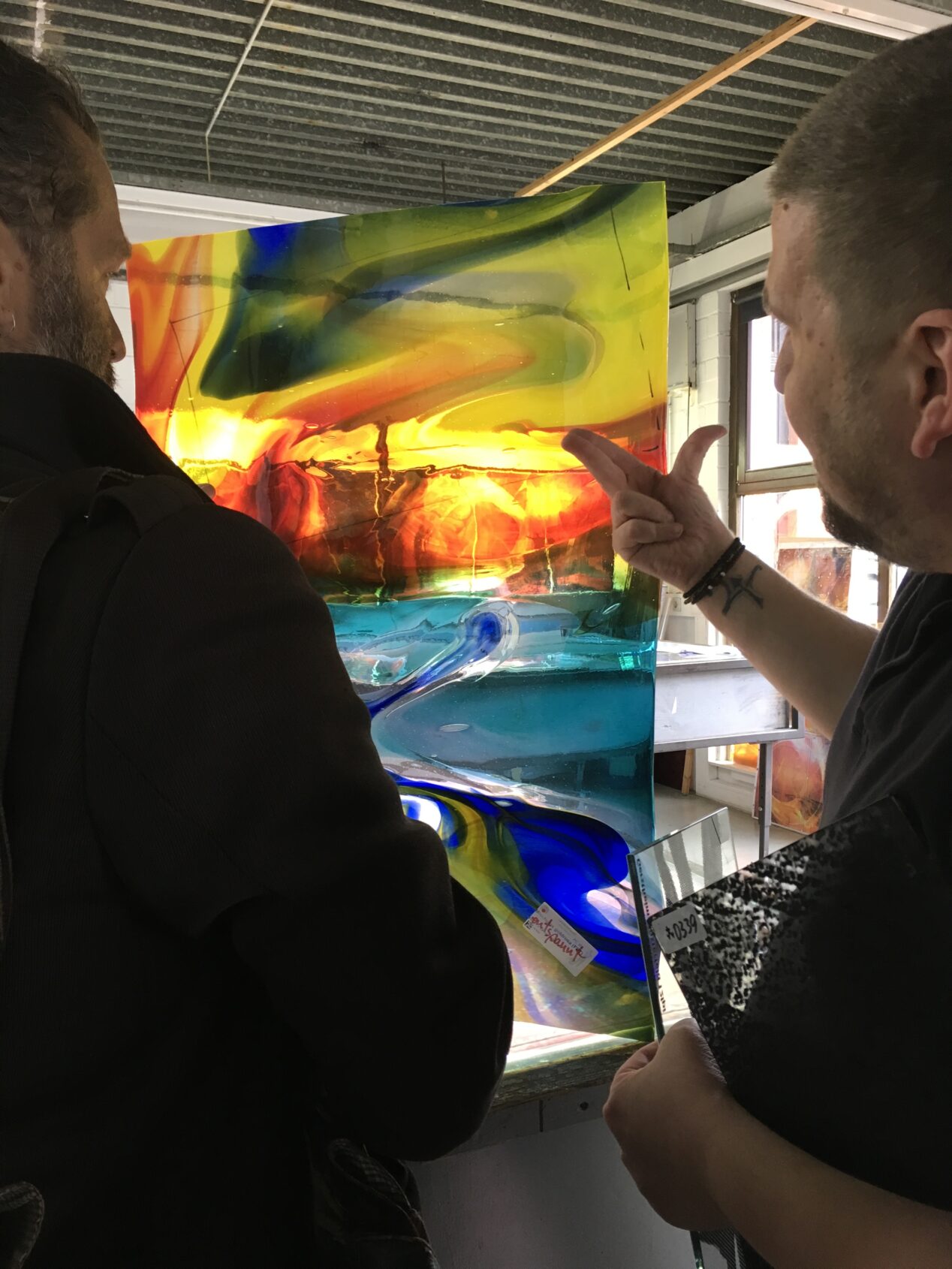 Olaf and Yvelle inspecting a piece of Lamberts' streaky (mischglas) glass.