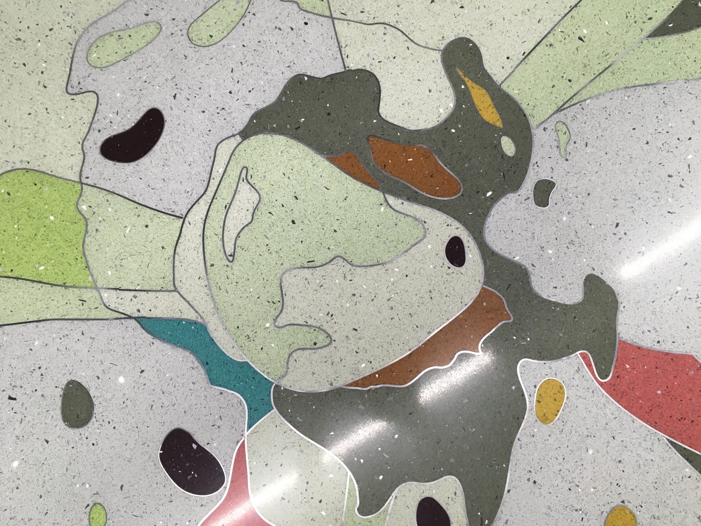 Detail of a flower an orange blossom flower in an epoxy terrazzo artistic design at the Orlando International Airport