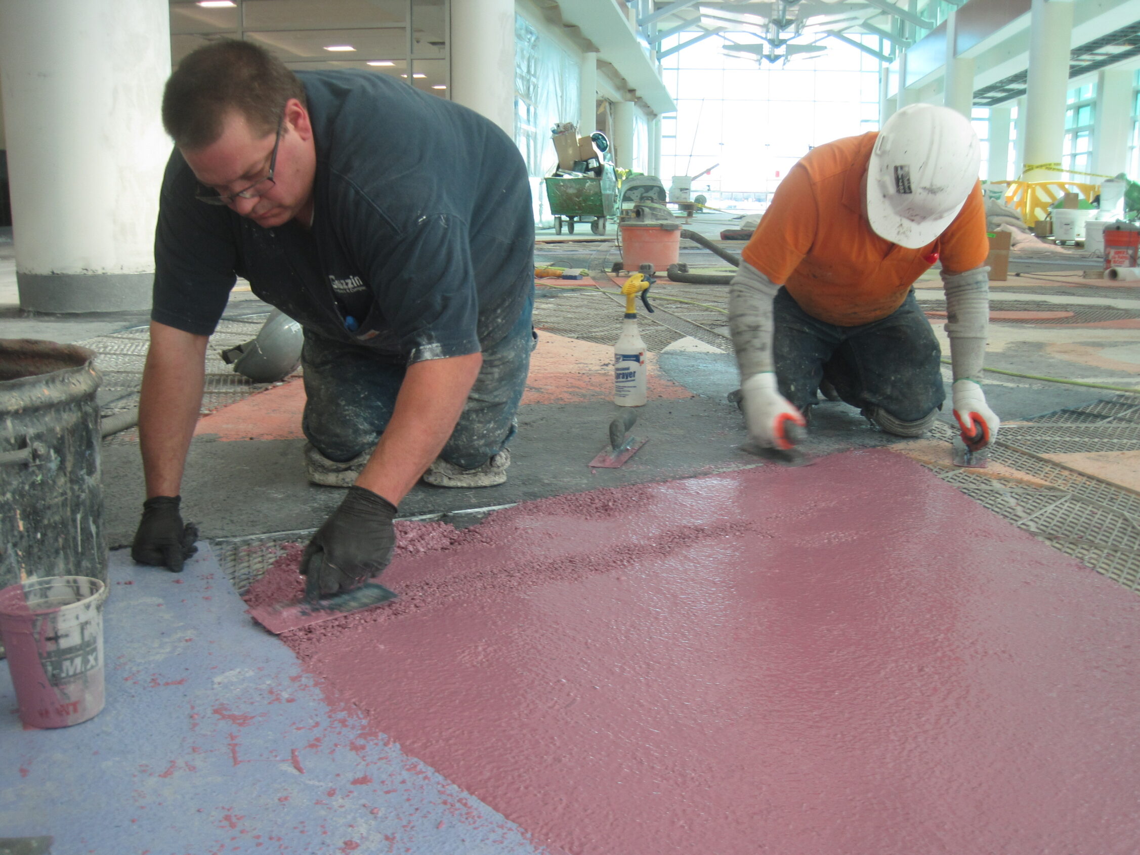 Troweling the purple epoxy terrazzo mix for the artistic terrazzo floor at the Minneapolis Airport.