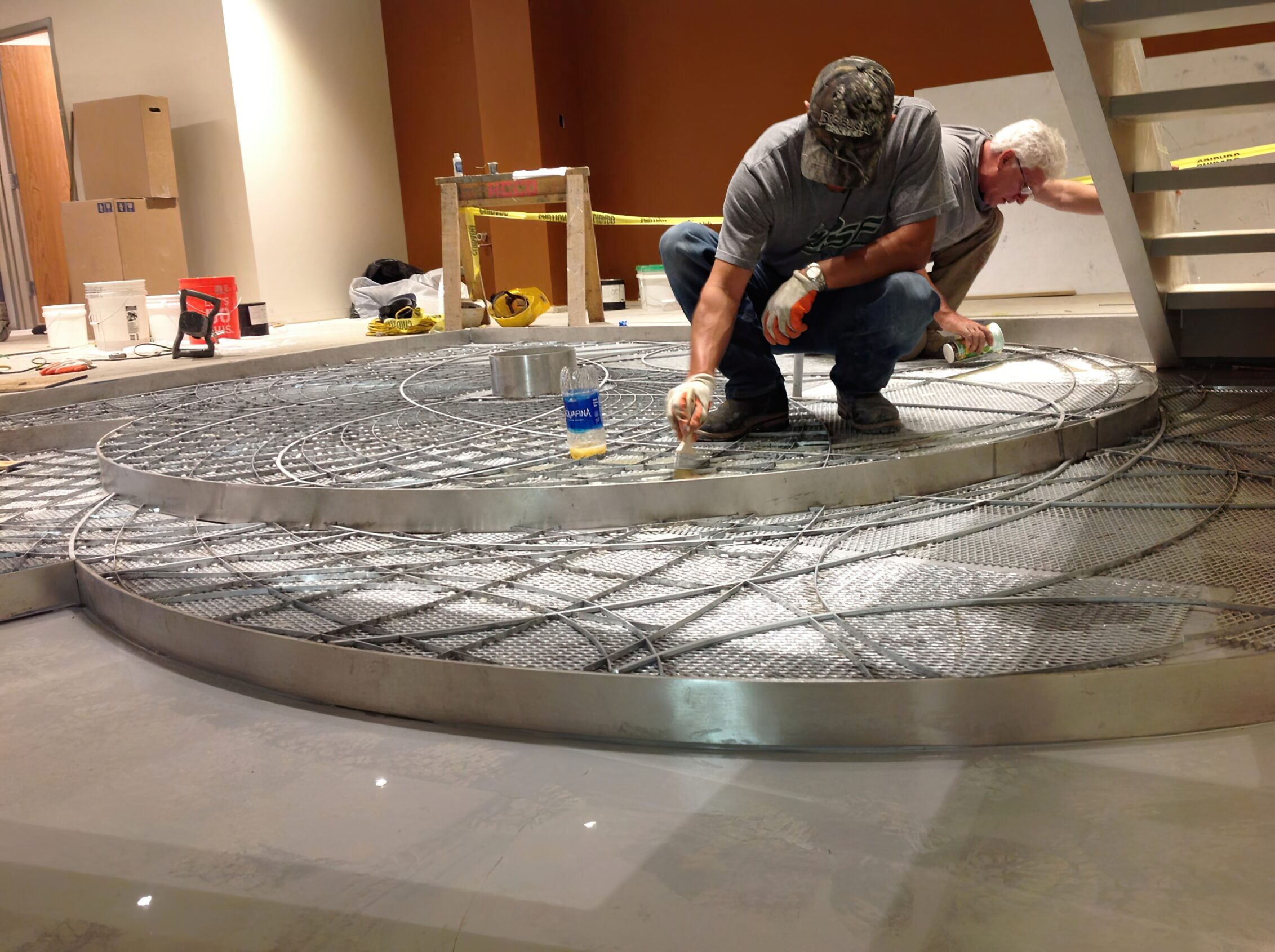 Foucault pendulum divider strip being cleaned and prepped before the epoxy terrazzo pour.