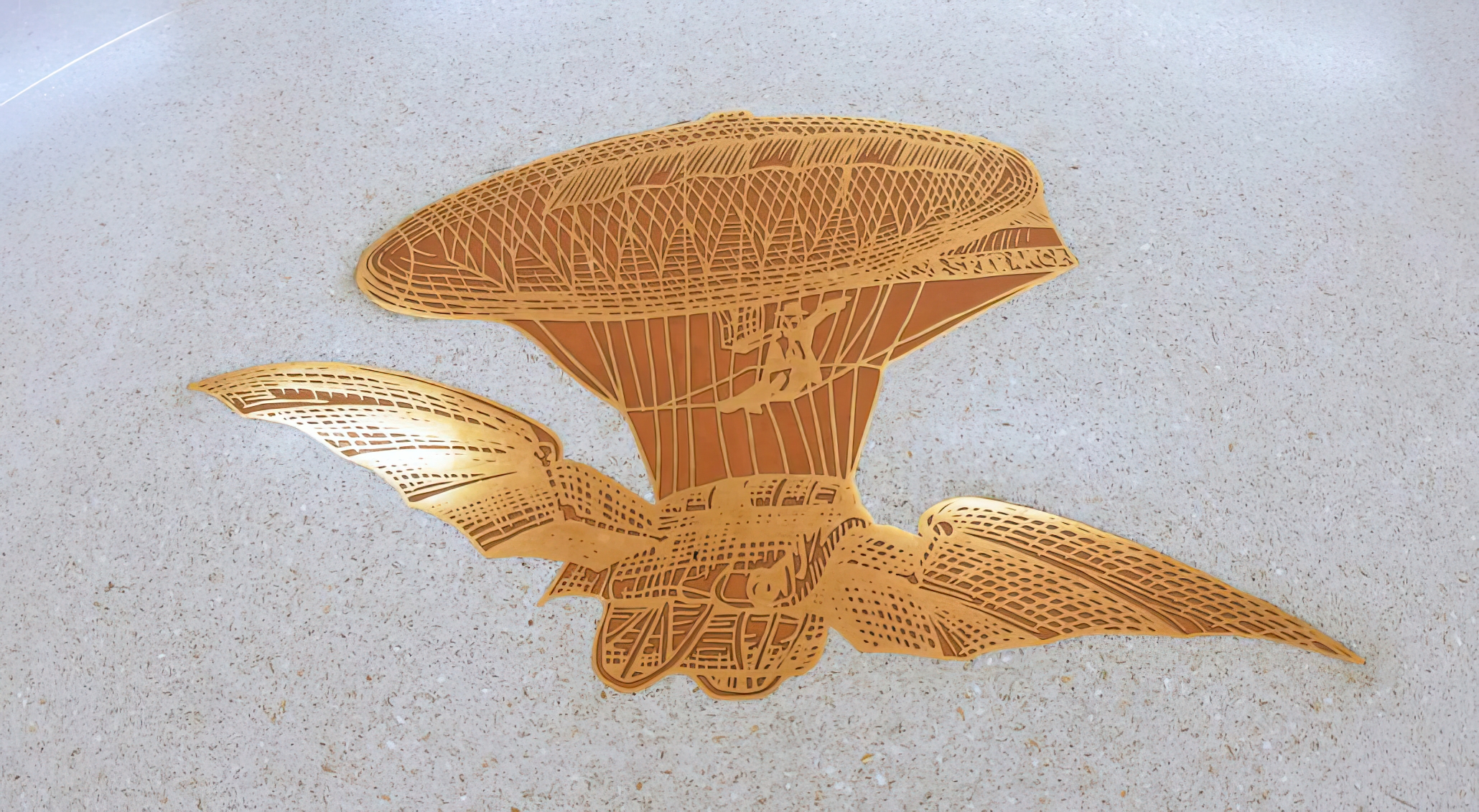 Flying machine cast bronze embed for the Fort Lauderdale-Hollywood International Airport epoxy terrazzo floor.