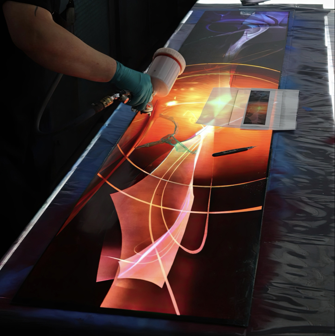 Airbrushing the intricate layers of vitreous enamels for the Sister Death window.