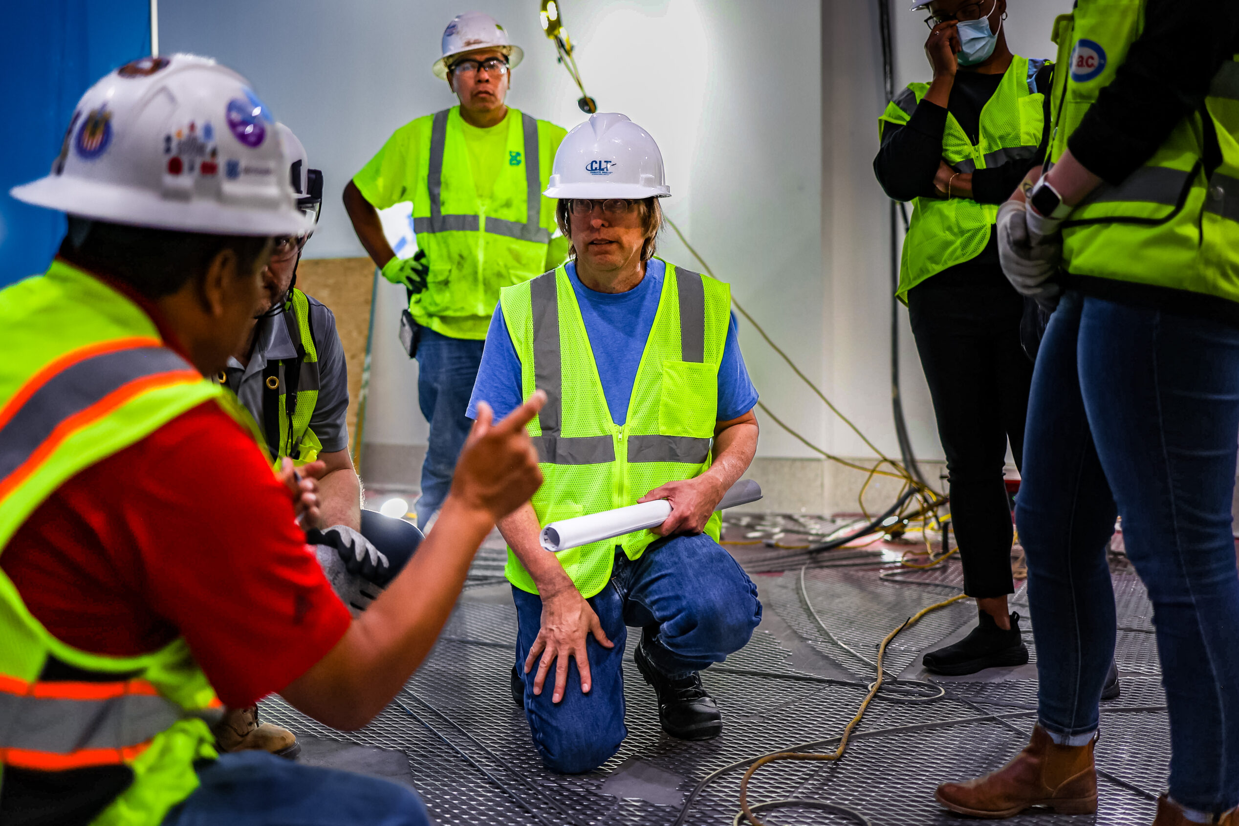 Scott Parsons and the David Allen Company terrazzo crew consulting about the divider strip layout at the Charlotte-Douglas International Airport