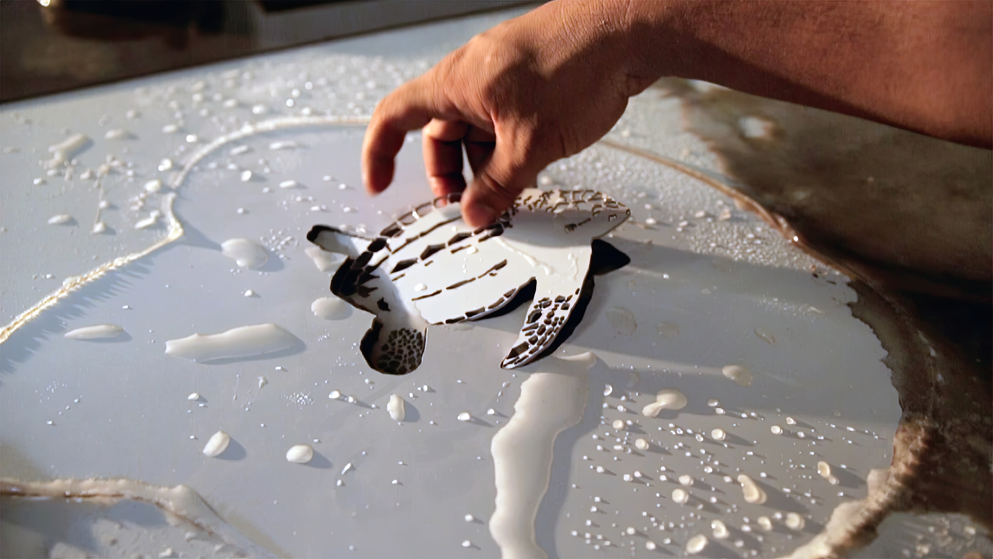 Waterjet-cut baby stainless steel turtle epoxy terrazzo embed for the Fort Lauderdale-Hollywood International Airport